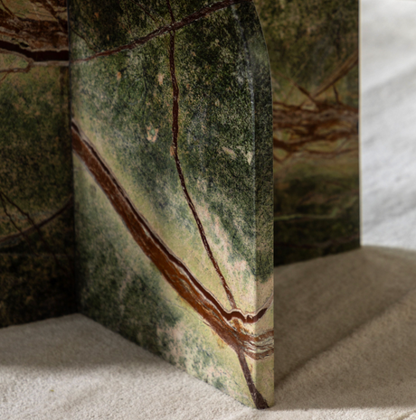 ember coffee table with brown veins on a sandy surface at the furniture sore ni