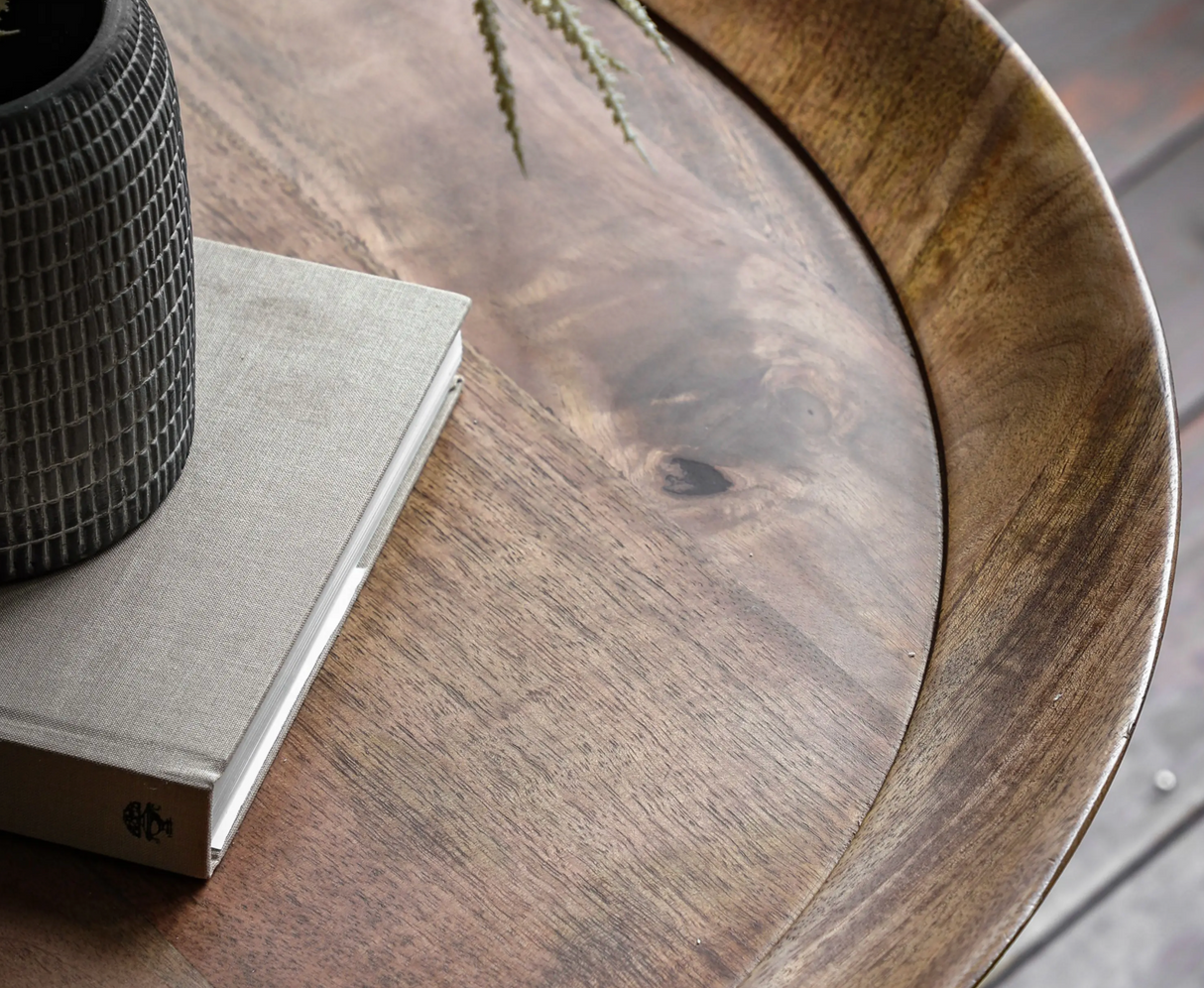 Wooden table with a book and decorative item on a blurred background