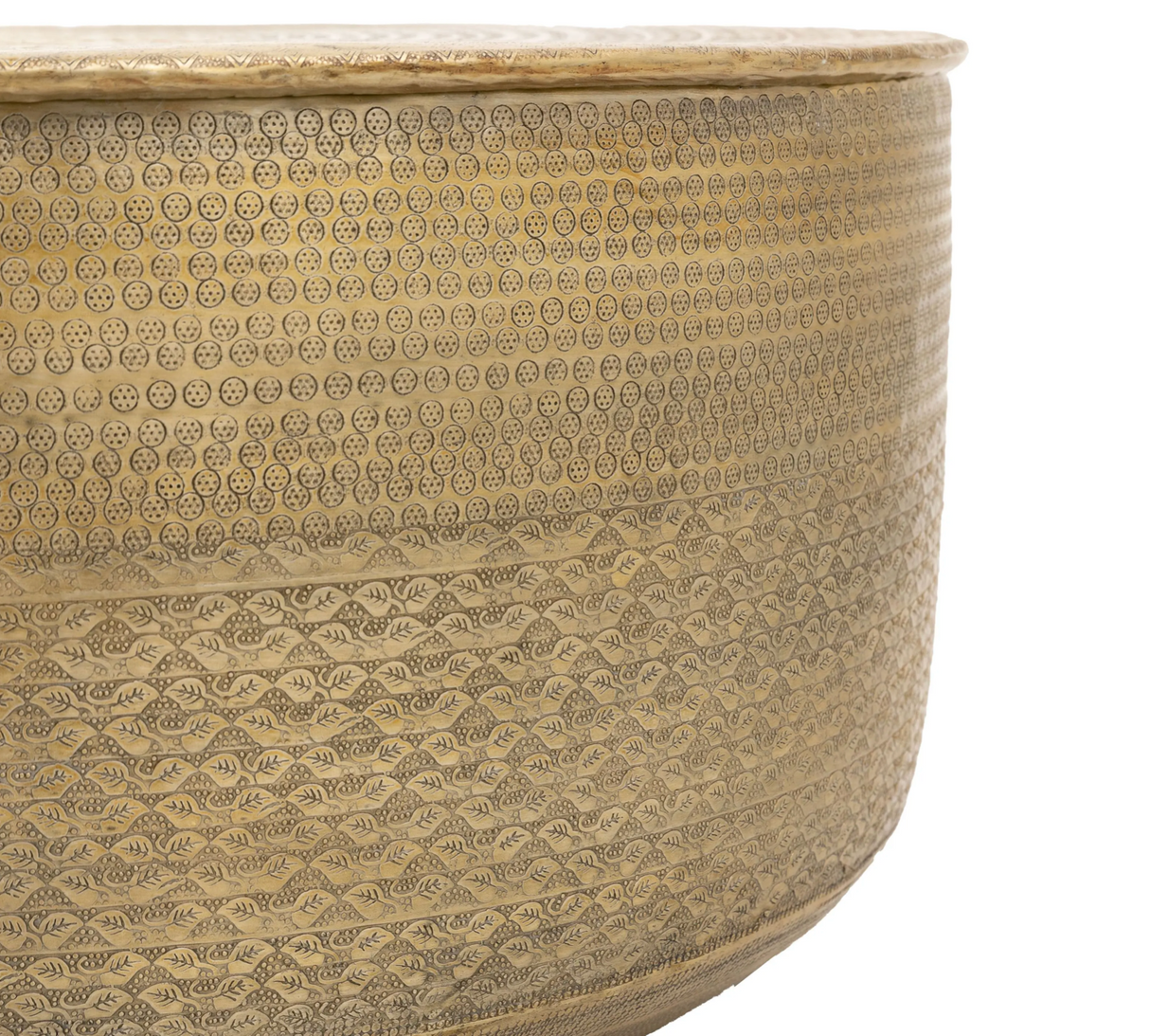 close up Ashta round embossed metal coffee table highlighting its glistening, hand-pressed metallic texture and low-profile contemporary silhouette.