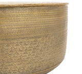 close up Ashta round embossed metal coffee table highlighting its glistening, hand-pressed metallic texture and low-profile contemporary silhouette.