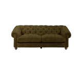 Modern 3-seater Chesterfield sofa showcasing its deep-buttoned back, elegant scrolled arms, and gracefully contoured silhouette sitting on solid ash legs Celine olive at the furniture store ni