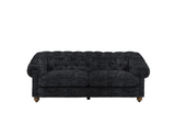 Modern 3-seater Chesterfield sofa showcasing its deep-buttoned back, elegant scrolled arms, and gracefully contoured silhouette sitting on solid ash legs Celine olive at the furniture store ni