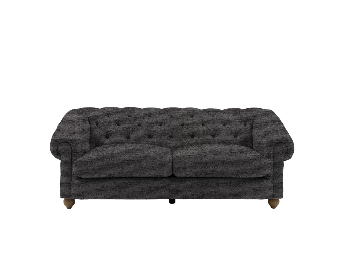 Modern 3-seater Chesterfield sofa showcasing its deep-buttoned back, in Mika ashen, elegant scrolled arms, and gracefully contoured silhouette sitting on solid ash legs at the furniture store ni 