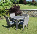 Naples 4-seater garden dining set with rattan armchairs, grey cushions, and a rustic wood-effect tabletop at the furniture store ni