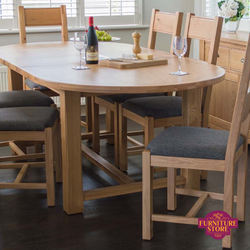 Breeze extending oval solid oak dining table, comes with 6 ladderback chairs and leather seat padding.