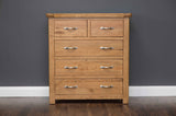 Manhattan 5-drawer chest in hand-crafted solid oak with modern chrome handles and natural wax finish.