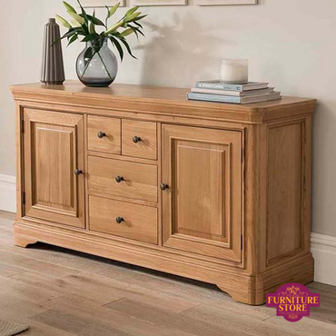 The Solid Oak Sideboard - 1550mm and has 2 doors and 4 drawers. It has brass handles.