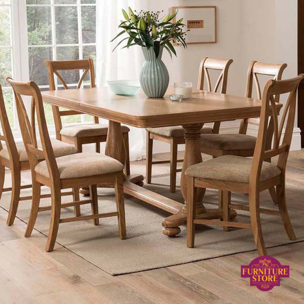 Solid oak dining table with double pedelstal design underneath and 6 oak chairs with cream padding chairs and v stle backs