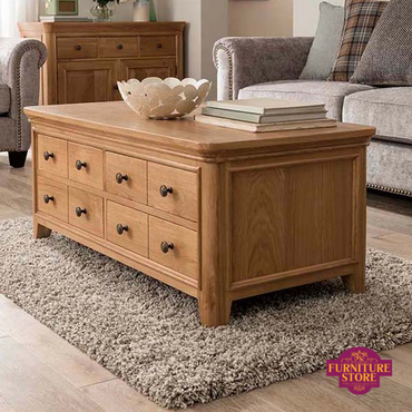 Carmen Solid Oak Coffee Table with 8 drawers and brass round handles.